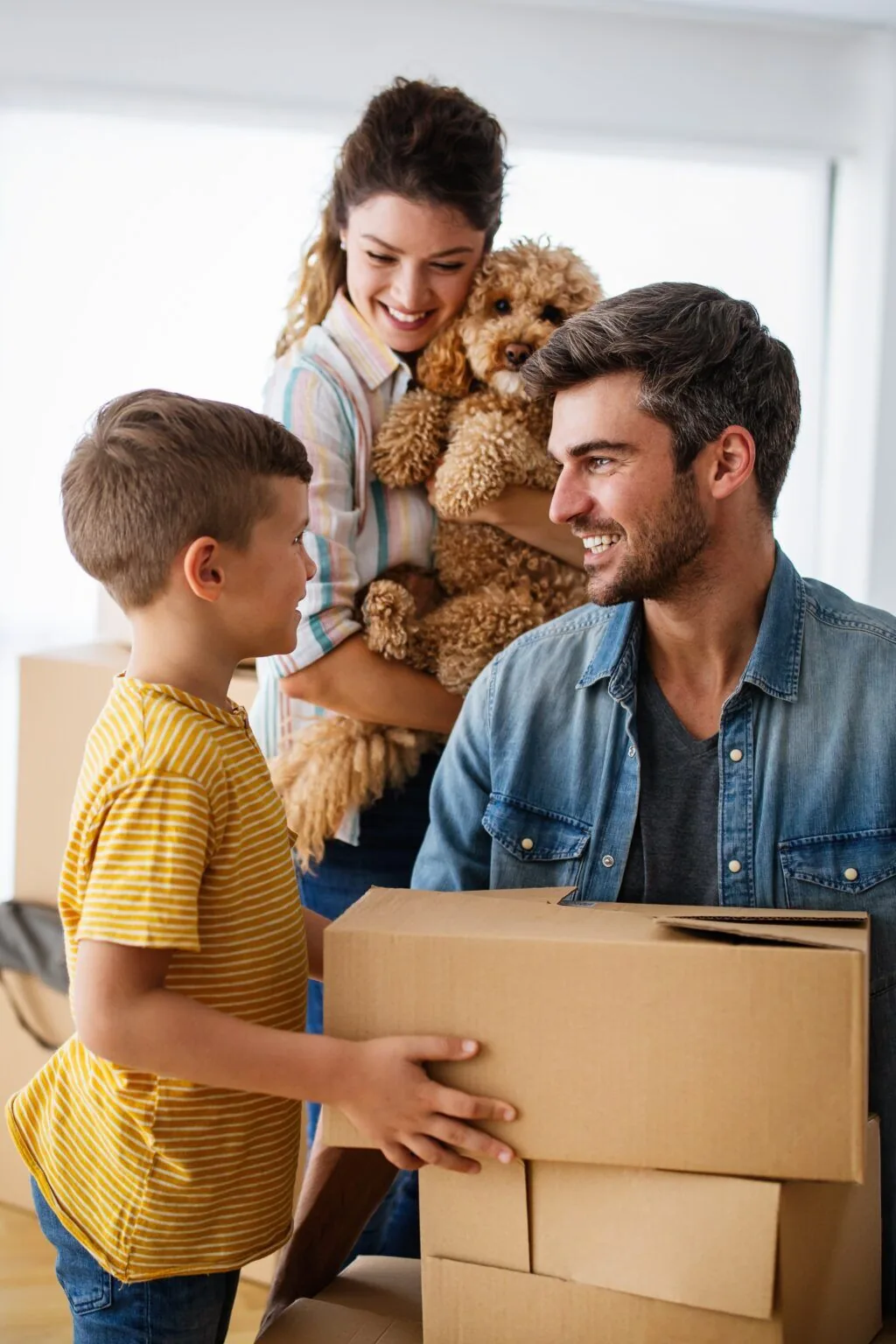 Happy family with their dog moving into a new home